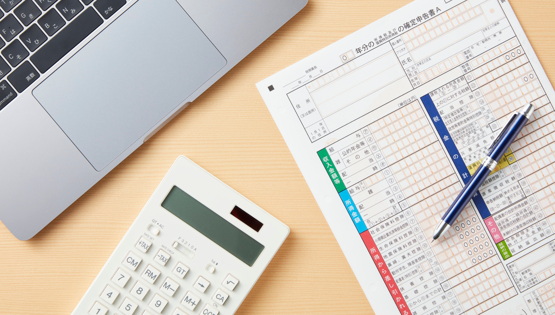 Tax preparation documents with calculator, laptop and financial records for business tax planning